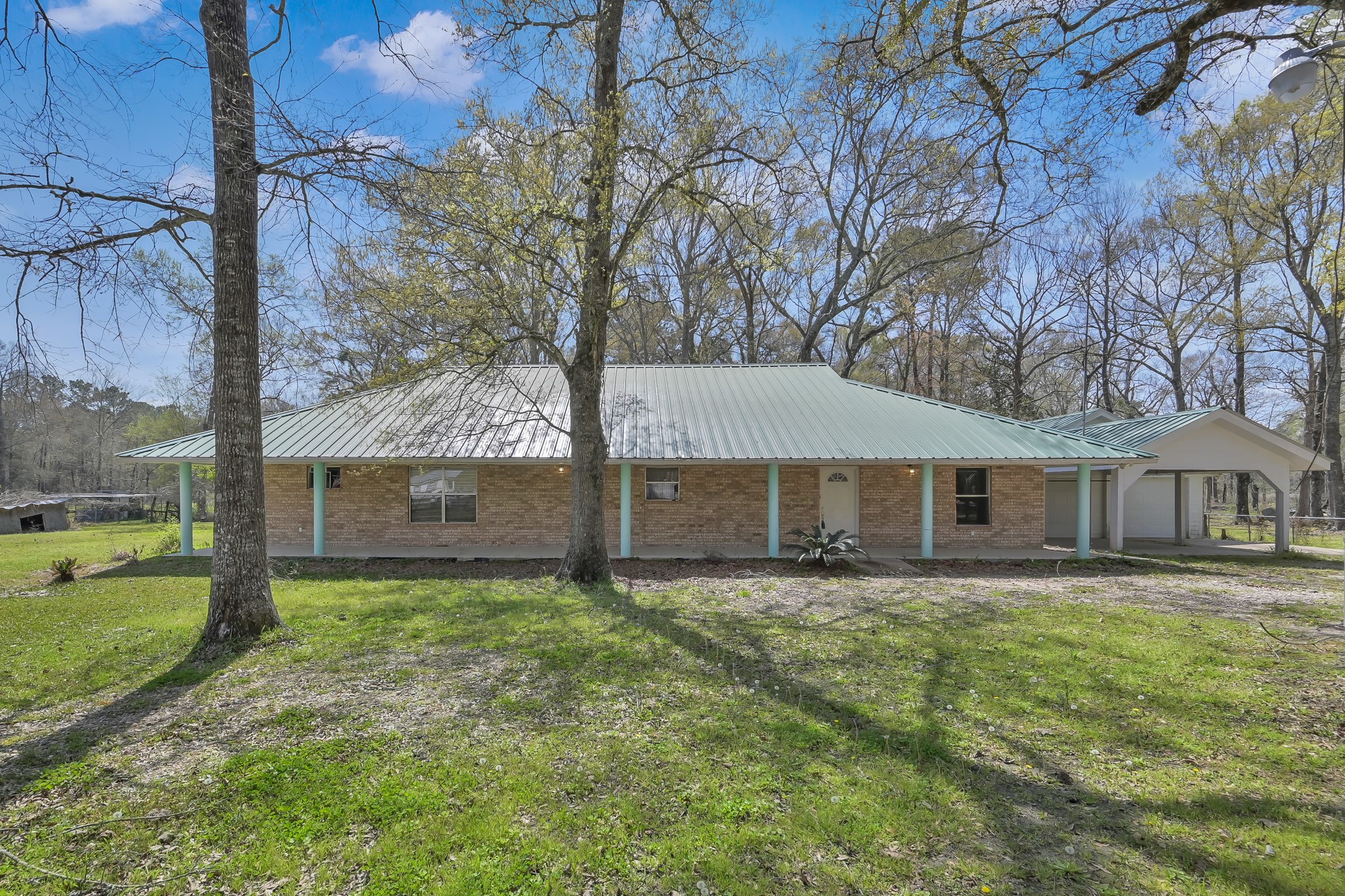 a front view of house with yard and trees