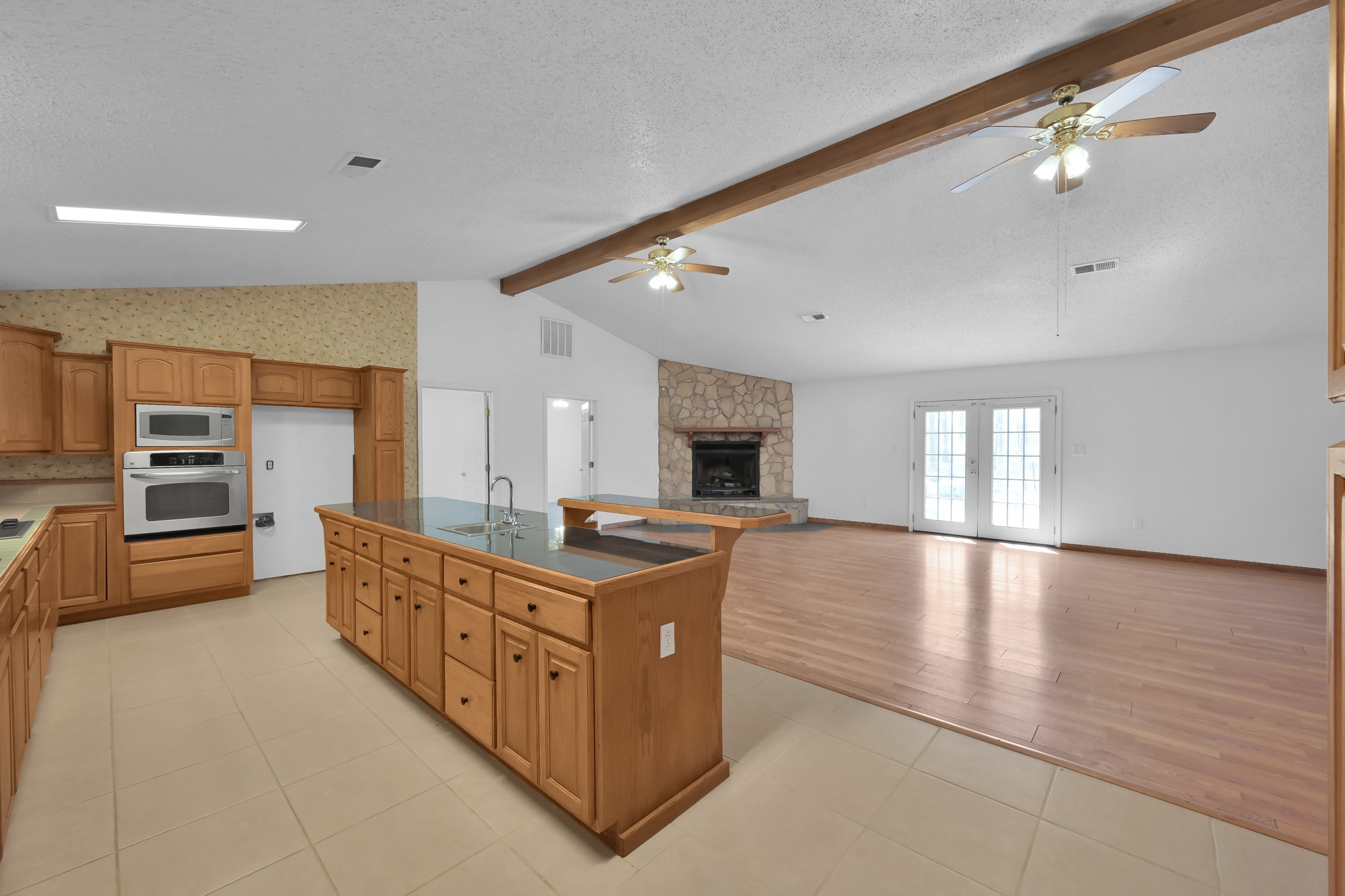 121 Magnolia Boulevard New Caney, TX 77357 - Photo 13 of 39 a kitchen with stainless steel appliances granite countertop a stove and a large refrigerator