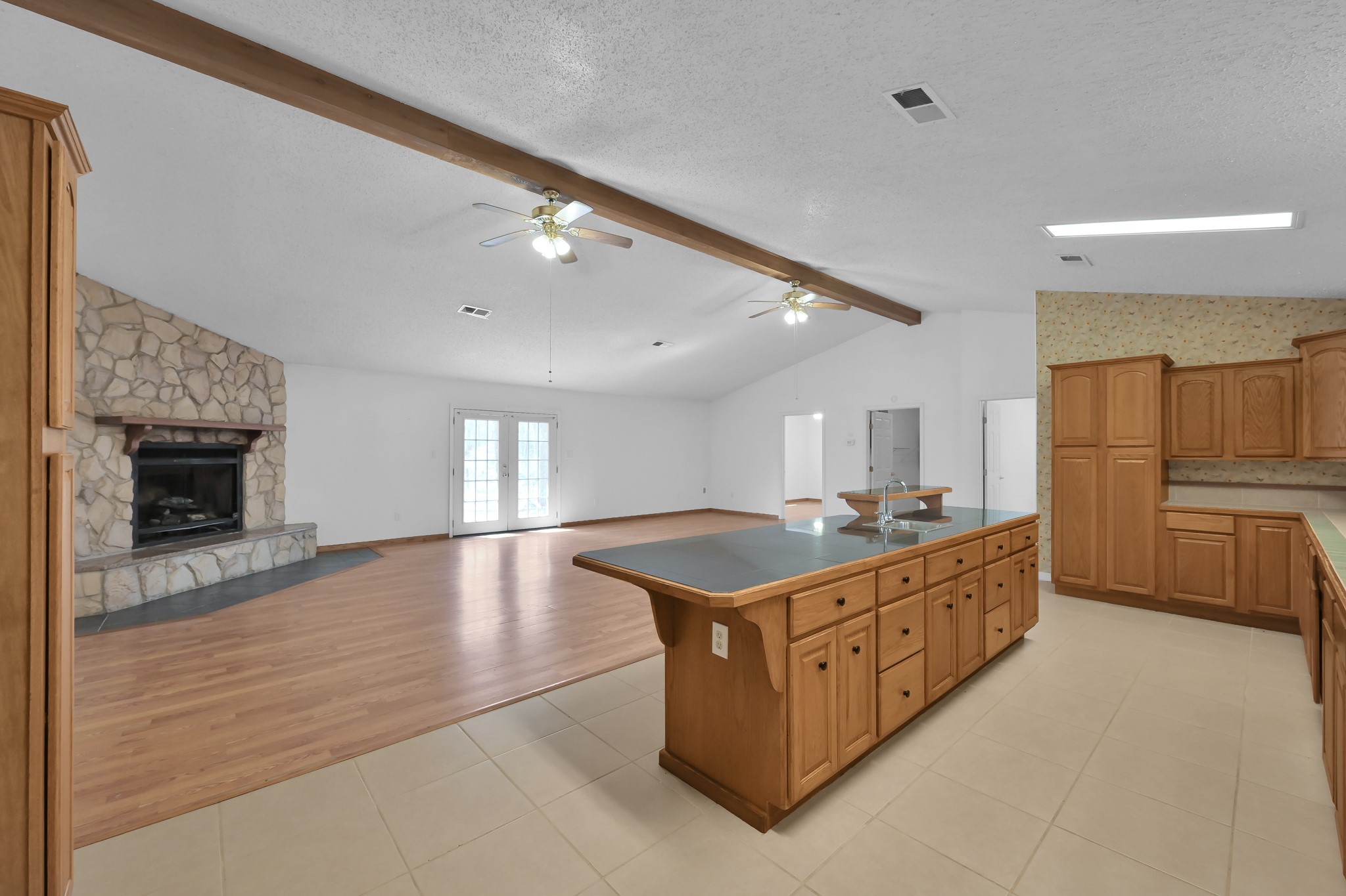 121 Magnolia Boulevard New Caney, TX 77357 - Photo 14 of 39 a kitchen with stainless steel appliances granite countertop a stove a sink and a refrigerator