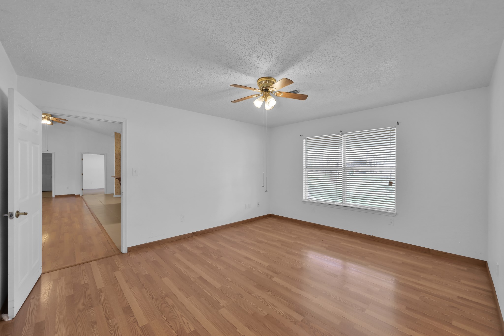 121 Magnolia Boulevard New Caney, TX 77357 - Photo 17 of 39 a view of an empty room with a window and a kitchen