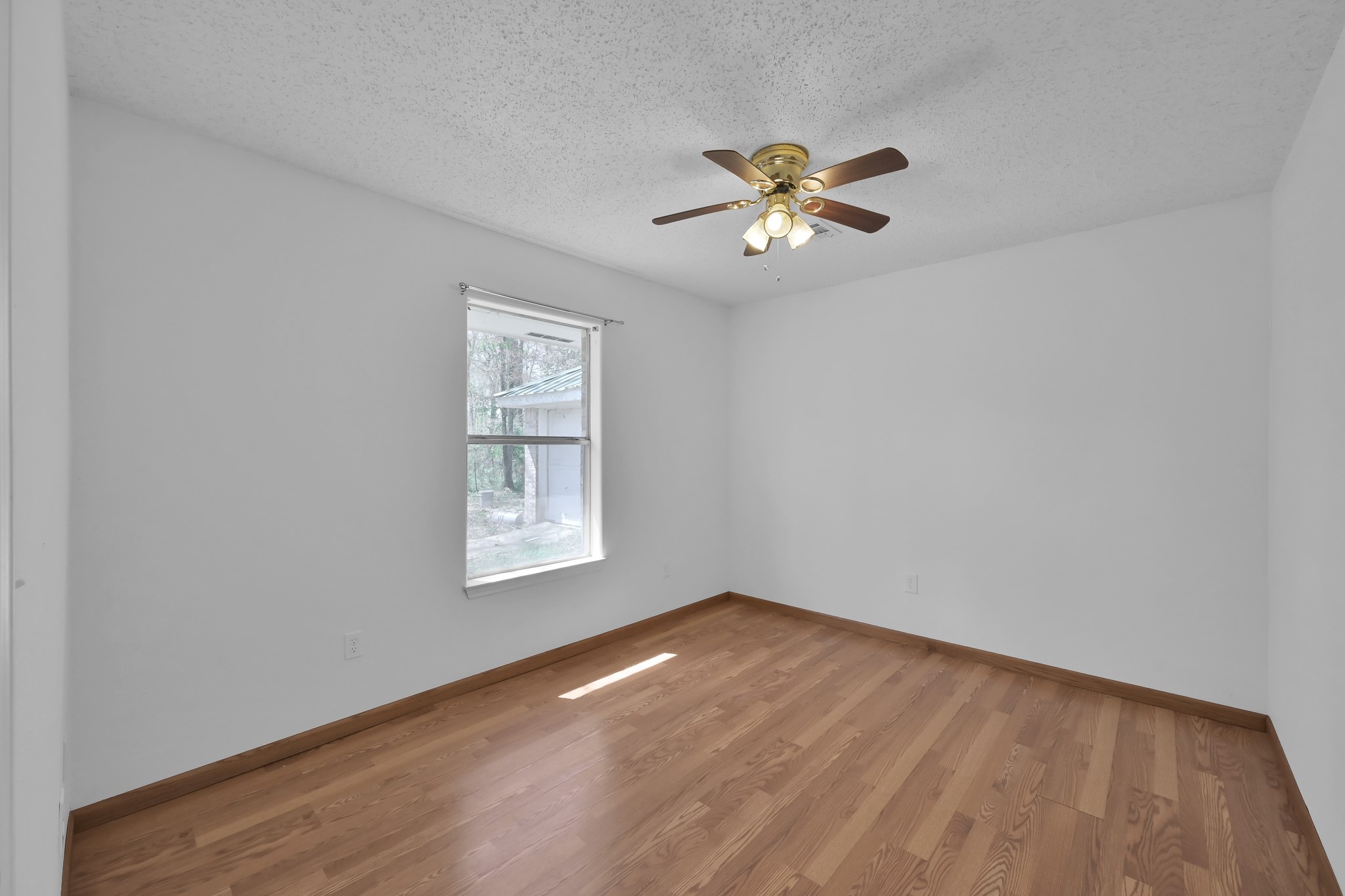 121 Magnolia Boulevard New Caney, TX 77357 - Photo 31 of 39 a view of empty room with window and wooden floor