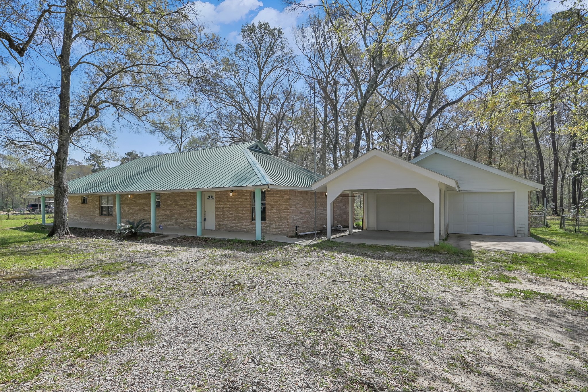 121 Magnolia Boulevard New Caney, TX 77357 - Photo 4 of 39 a house with trees in front of it