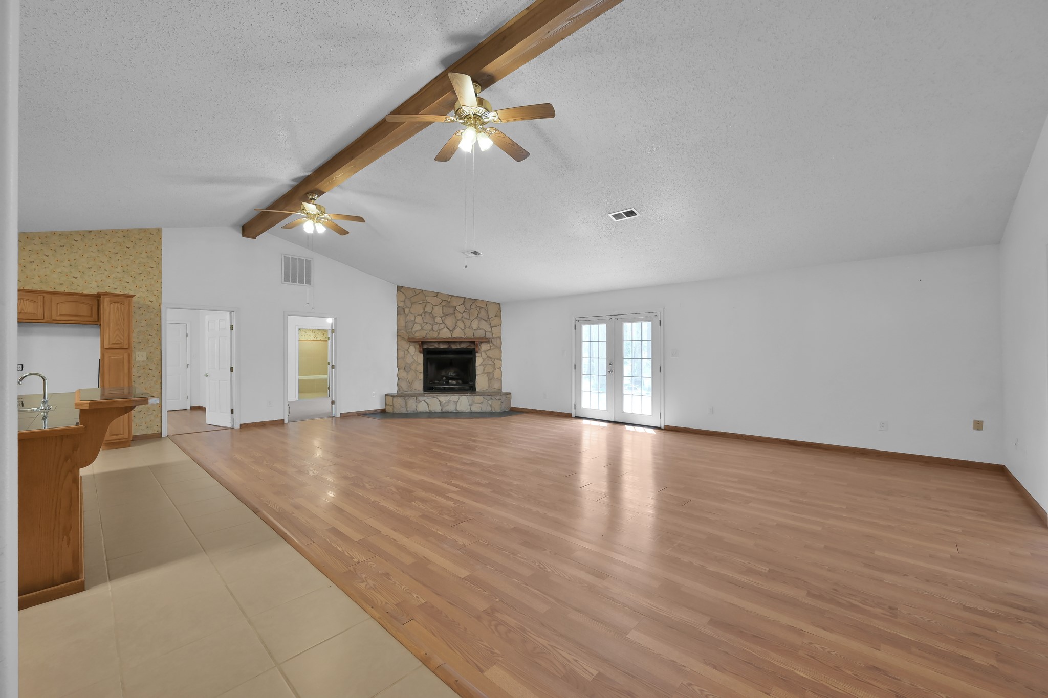 121 Magnolia Boulevard New Caney, TX 77357 - Photo 8 of 39 a view of empty room with wooden floor and fireplace