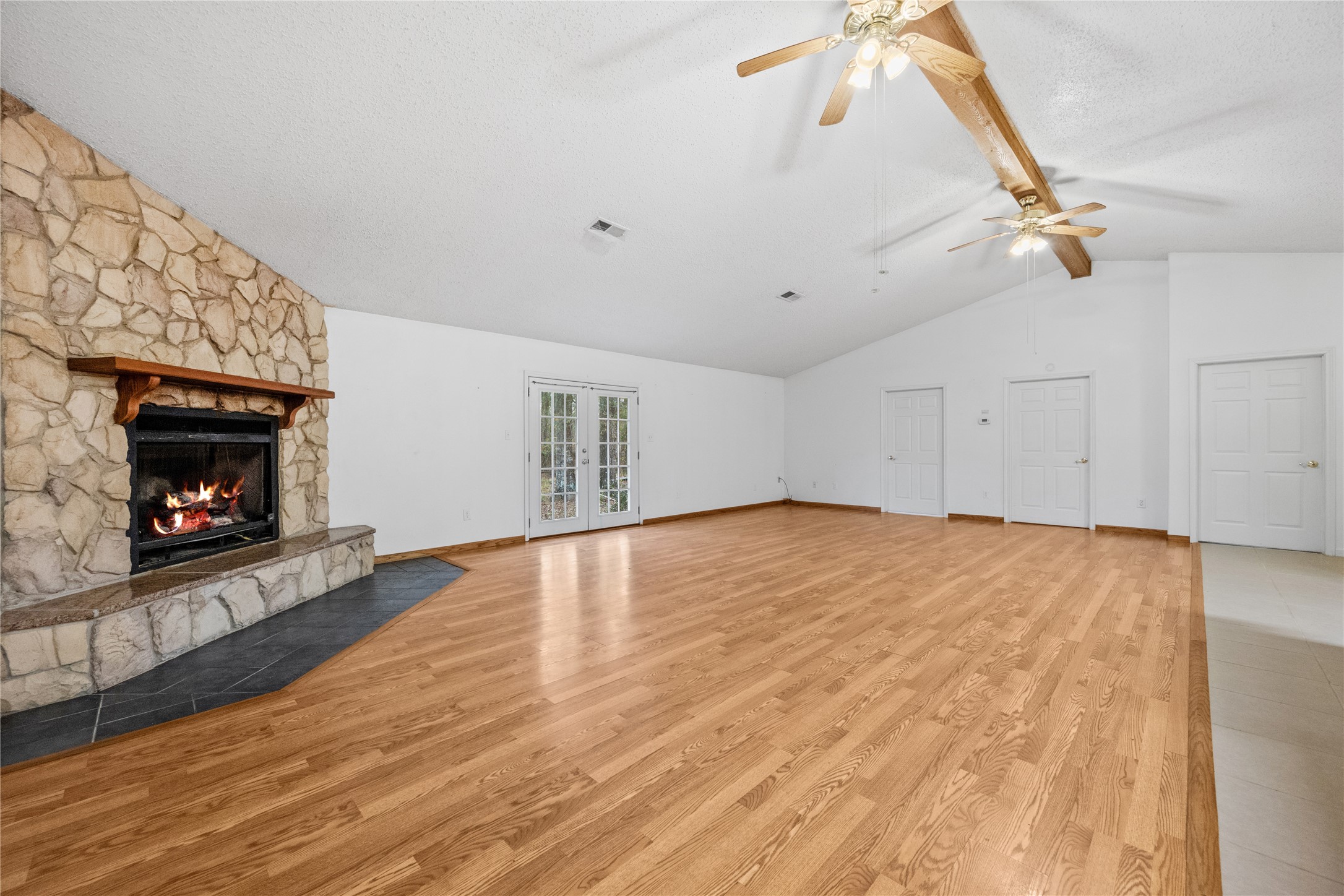 121 Magnolia Boulevard New Caney, TX 77357 - Photo 9 of 39 a view of empty room with wooden floor and fireplace