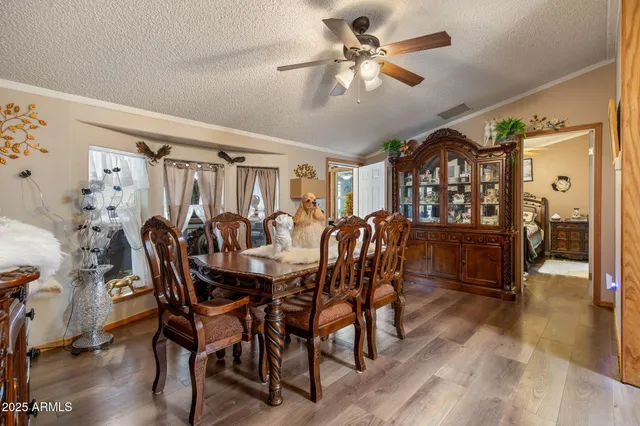 a kitchen with a table chairs refrigerator and microwave