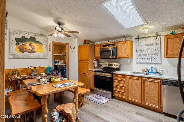 a view of a dining room with furniture a chandelier and wooden floor
