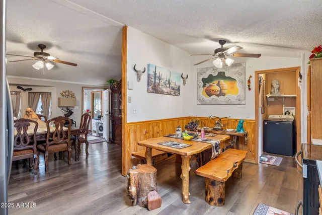 a living room with stainless steel appliances kitchen island granite countertop furniture and a refrigerator