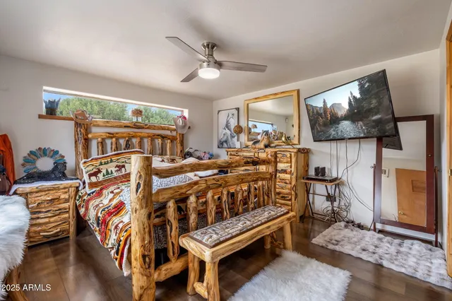 a bedroom with furniture and a large window