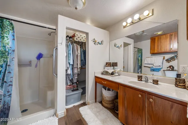 a bedroom with a bed and wooden furniture