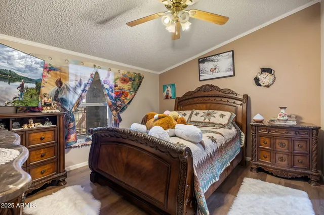 a bedroom with a bed and a mirror on the dresser