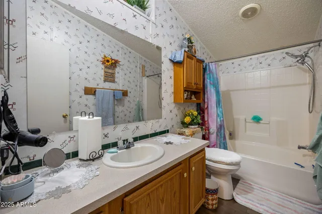 a bed room with a bed and a painting on the wall