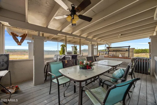 a view of a hallway with wooden floor and a dining space