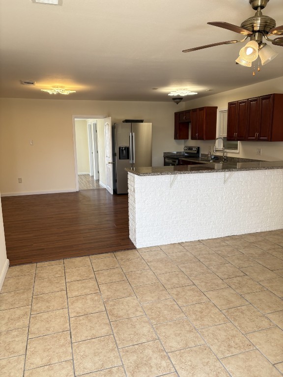 7220 Avenue R Galveston, TX 77551 - Photo 3 of 8 a view of kitchen with furniture and a refrigerator