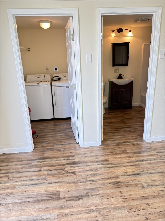 7220 Avenue R Galveston, TX 77551 - Photo 7 of 8 a view of a hallway and wooden floor and a bathroom