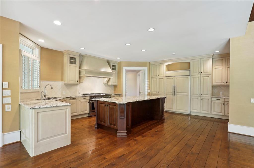 1965 West Wesley Road Northwest Atlanta, GA 30327 - Photo 21 of 34 a kitchen with stainless steel appliances granite countertop a stove and a sink