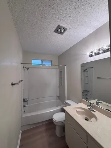 a bathroom with a sink toilet tub and shower