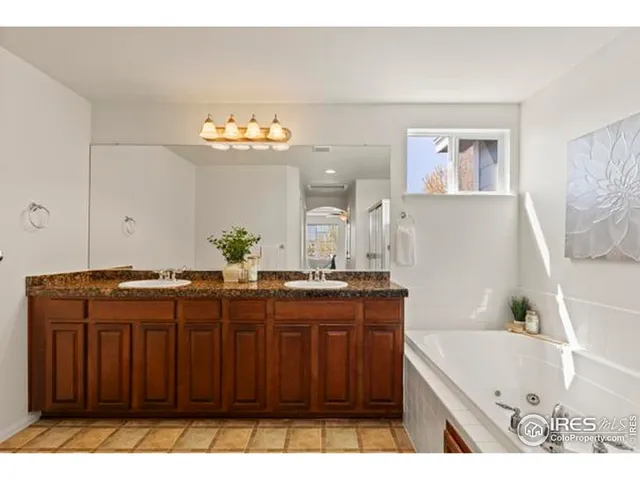 a bathroom with a tub a sink and a mirror
