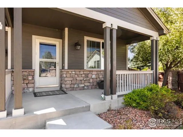 a view of a porch with a table and chairs