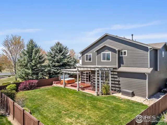 a view of a house with a yard and sitting area