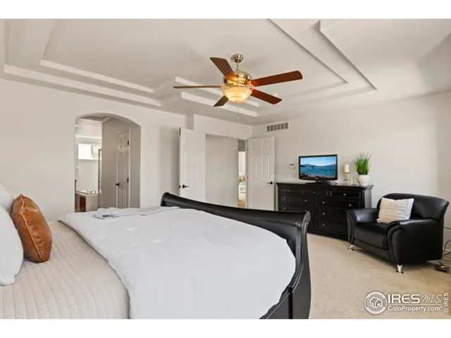 a bedroom with a bed and a television