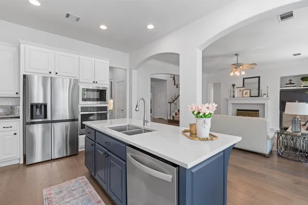 a kitchen with stainless steel appliances granite countertop a sink refrigerator and microwave