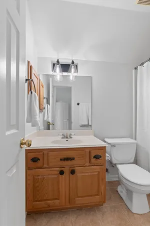 a white toilet sitting next to a shower curtain