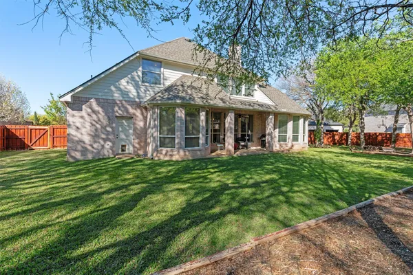 a house view with swimming pool in front of it