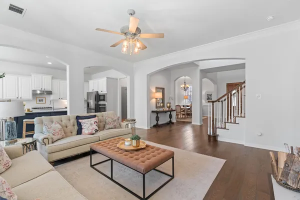 a living room with furniture and a dining table