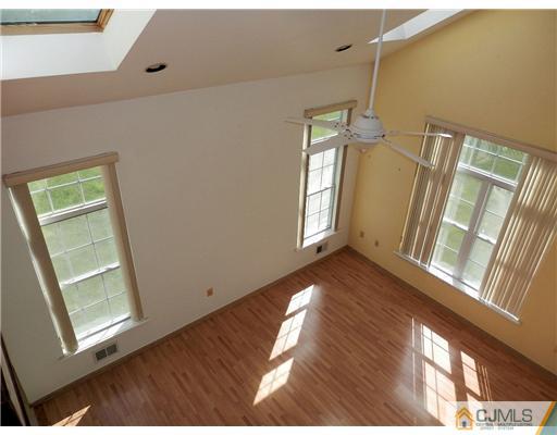 24 Lexington Road Monmouth Junction, NJ 08852 - Photo 11 of 21 a view of an empty room with wooden floor and a window