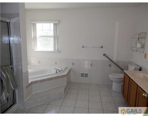 24 Lexington Road Monmouth Junction, NJ 08852 - Photo 18 of 21 a bathroom with a bathtub and a toilet