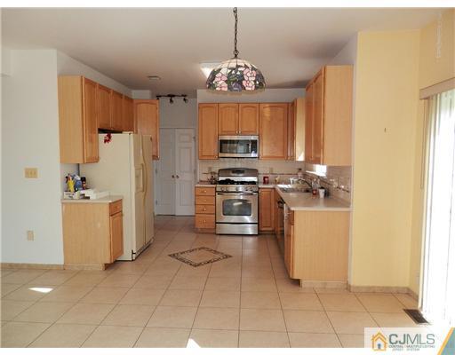 24 Lexington Road Monmouth Junction, NJ 08852 - Photo 7 of 21 a kitchen with microwave cabinets and a stove top oven