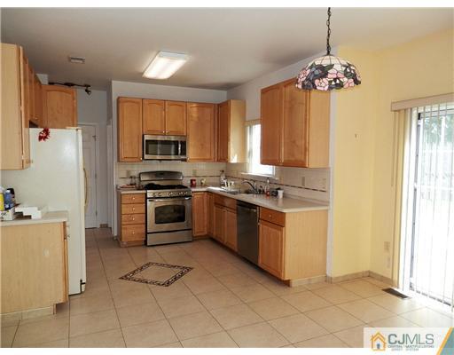 24 Lexington Road Monmouth Junction, NJ 08852 - Photo 8 of 21 a kitchen with stainless steel appliances granite countertop a stove a sink a refrigerator and a window