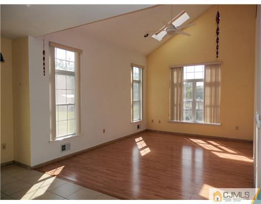 24 Lexington Road Monmouth Junction, NJ 08852 - Photo 9 of 21 a view of an empty room with wooden floor and a window