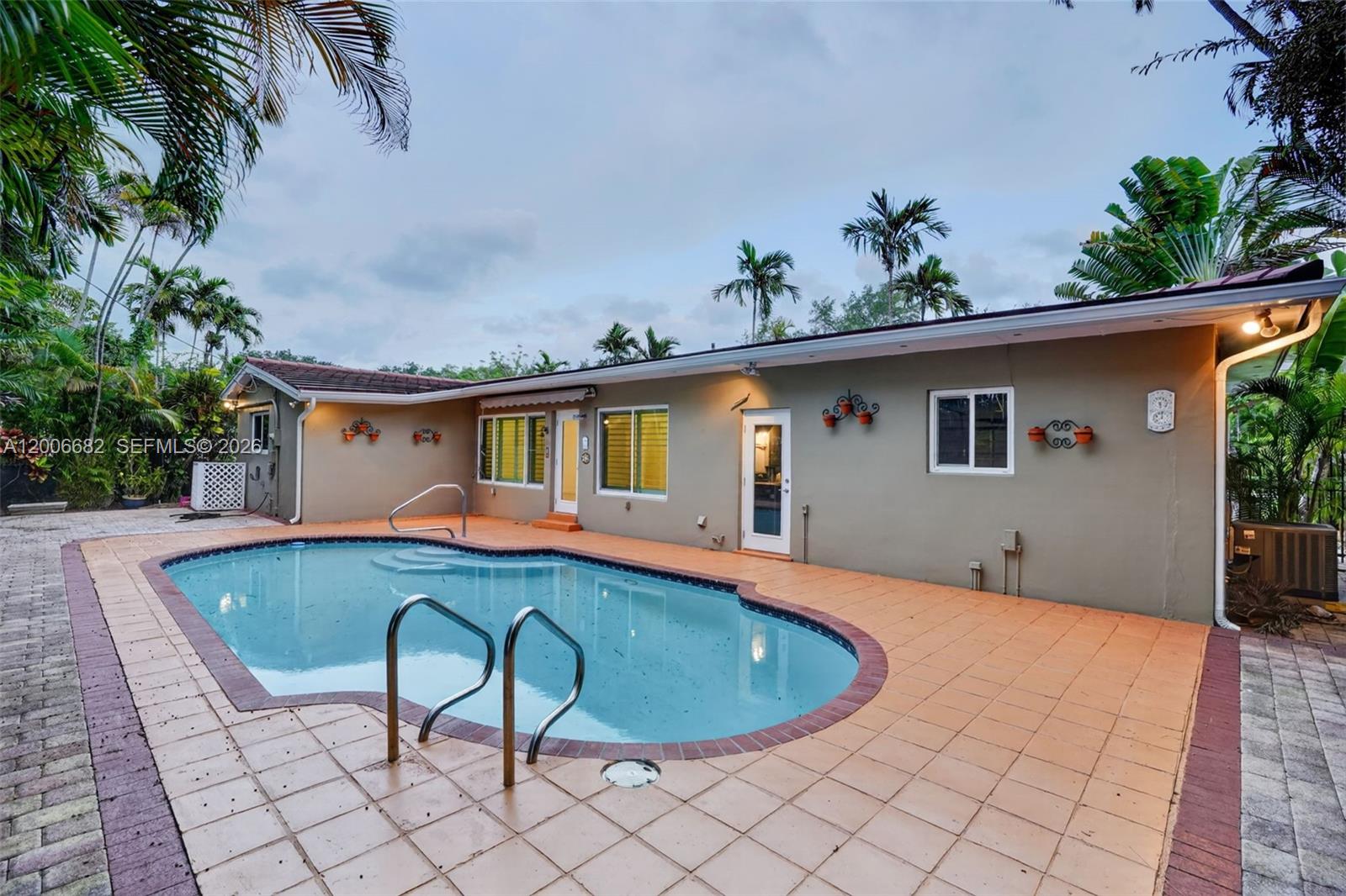 1435 Blue Road Coral Gables, FL 33146 - Photo 27 of 31 a view of a house with pool and sitting area