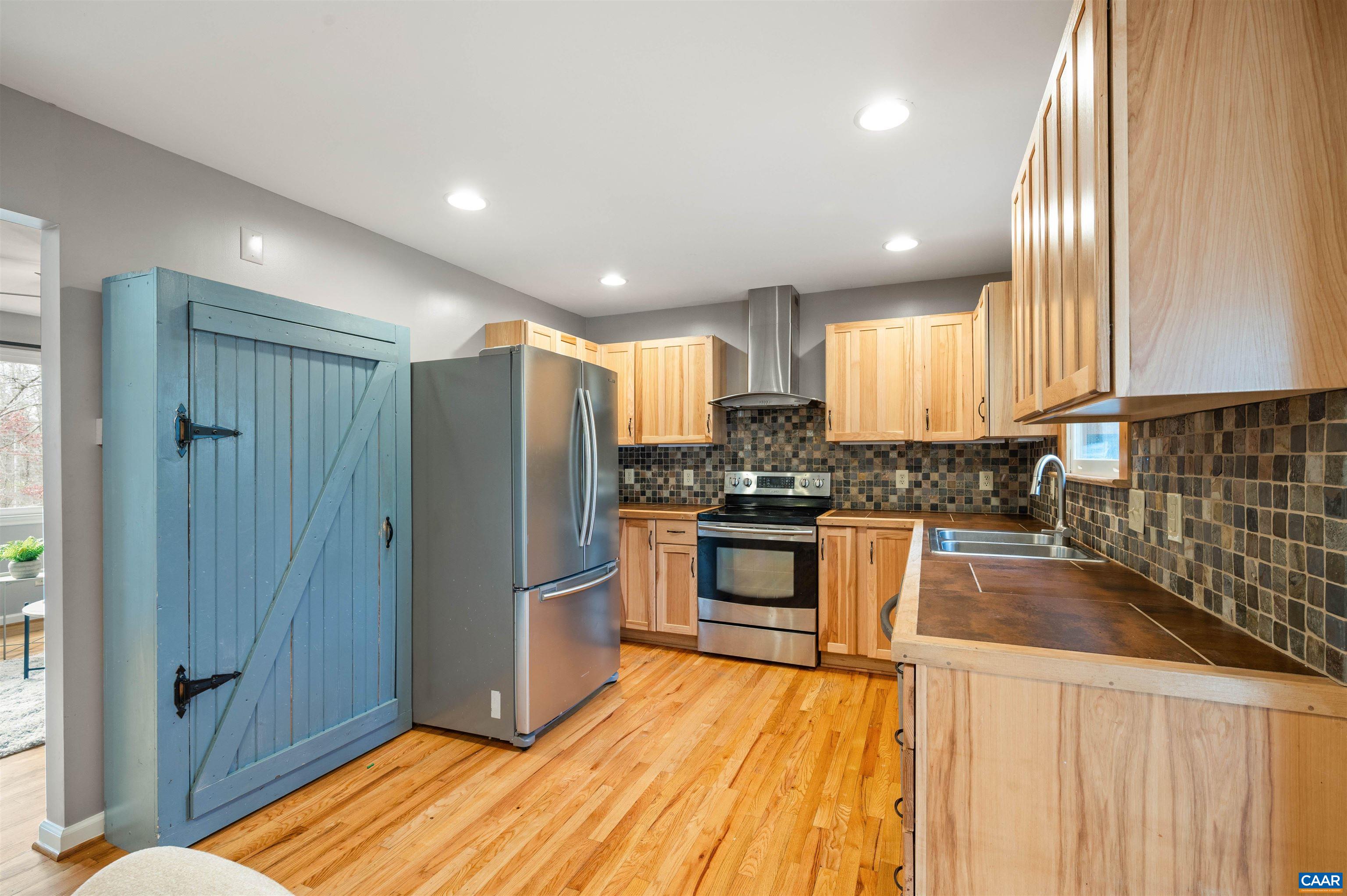 139 Fox Hollow Road Ruckersville, VA 22968 - Photo 7 of 54 a kitchen with granite countertop a refrigerator and wooden cabinets