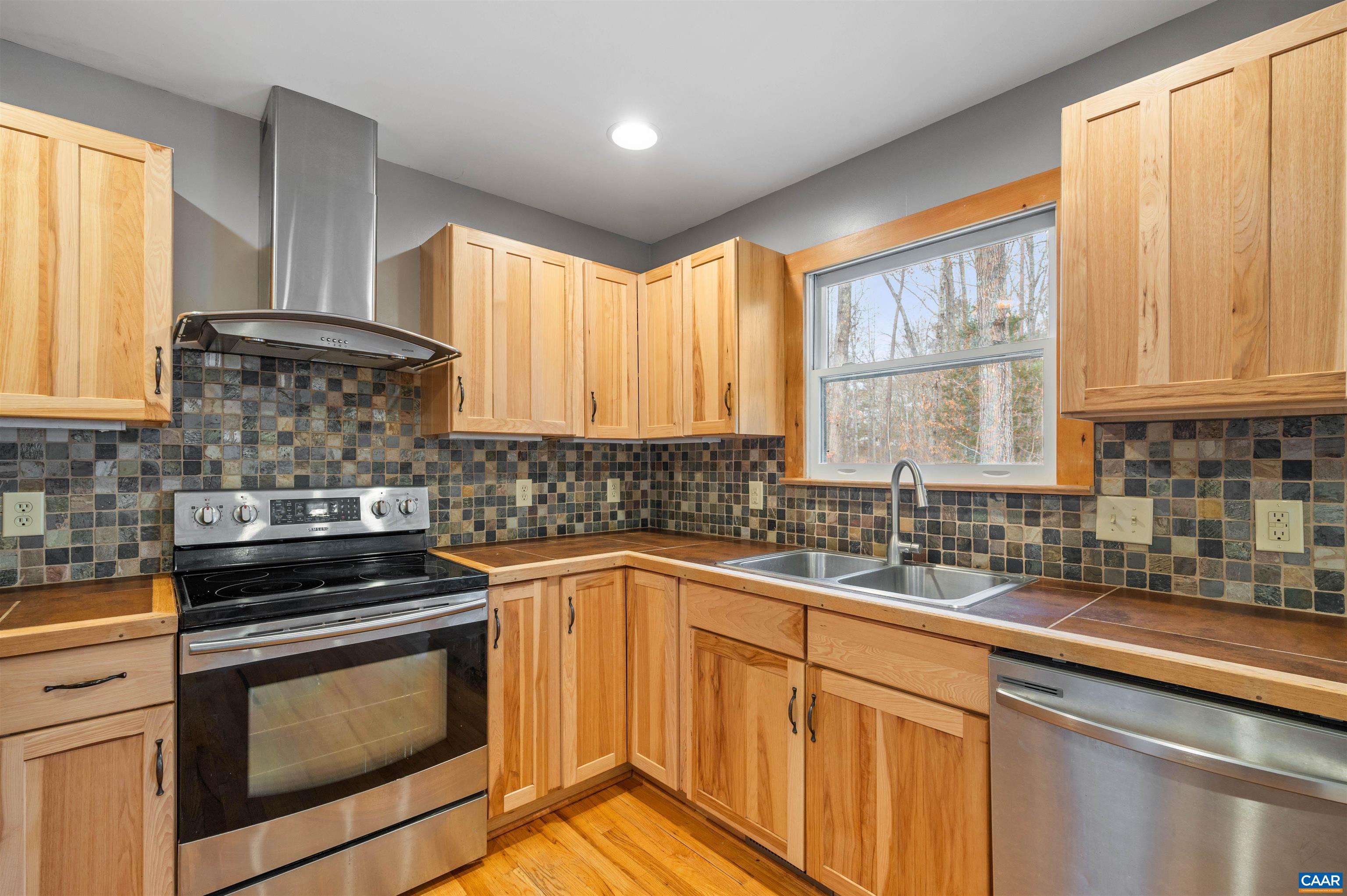 139 Fox Hollow Road Ruckersville, VA 22968 - Photo 9 of 54 a kitchen with a sink stove top oven and cabinets