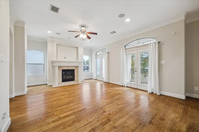 a view of an empty room with a fireplace and a window