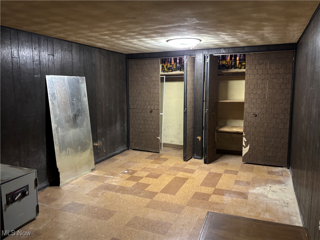 4308 Silsby Road University Heights, OH 44118 - Photo 23 of 28 Basement with a textured ceiling and wooden walls