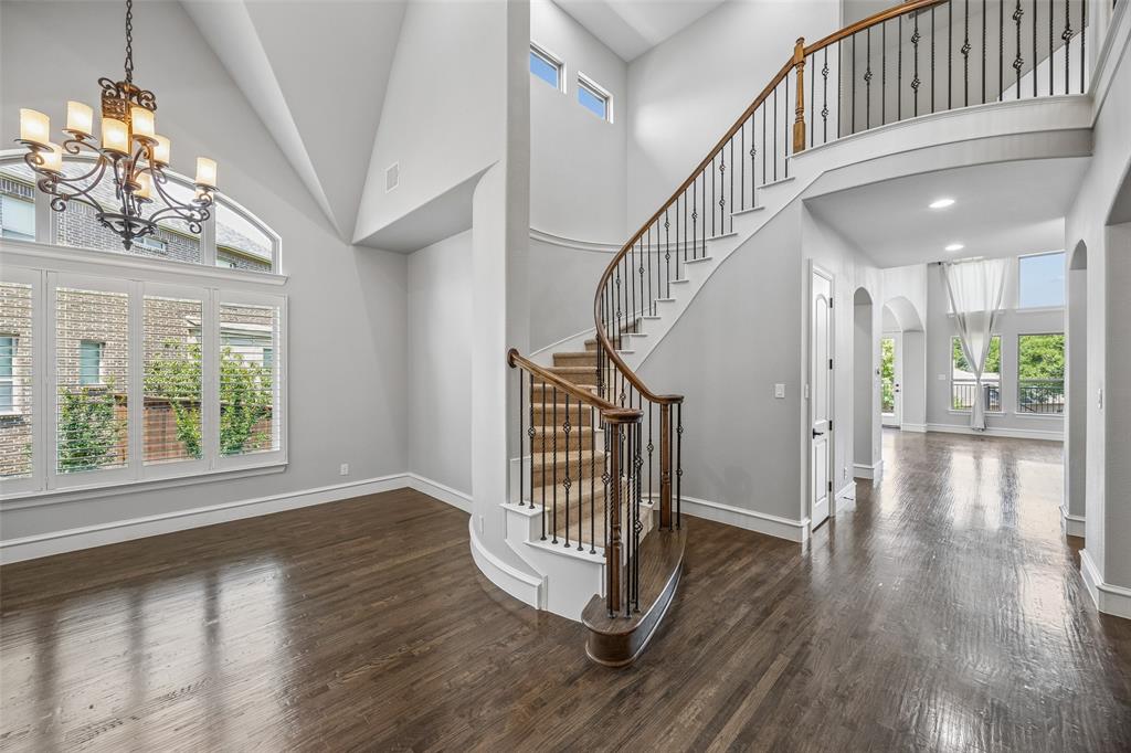 134 Santa Rosa Way Irving, TX 75062 - Photo 18 of 26 Grand entry featuring soaring ceilings, rich wood floors, and a sweeping staircase that makes a stunning first impression.