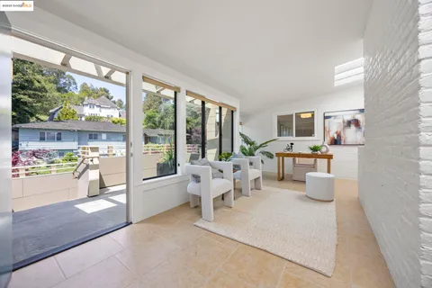 a living room with furniture and a floor to ceiling window