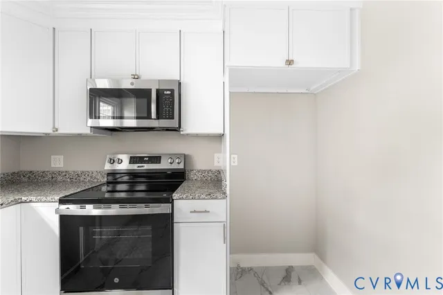 a kitchen with stainless steel appliances a stove a microwave and cabinets