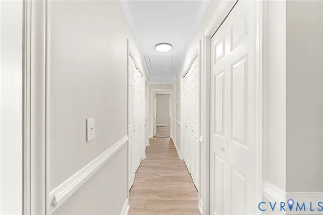 a view of a hallway with wooden floor and entryway