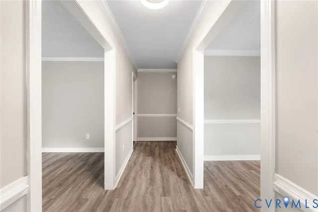 a view of a hallway with wooden floor