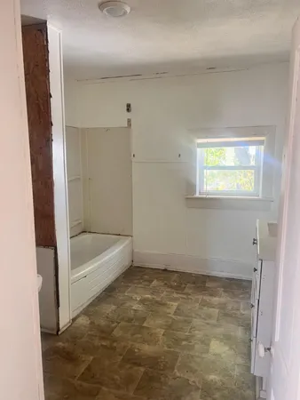 a bathroom with a tub and shower