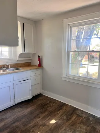 a kitchen with wooden cabinets and a window