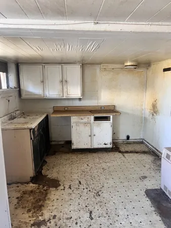 a kitchen with a sink stove and cabinets
