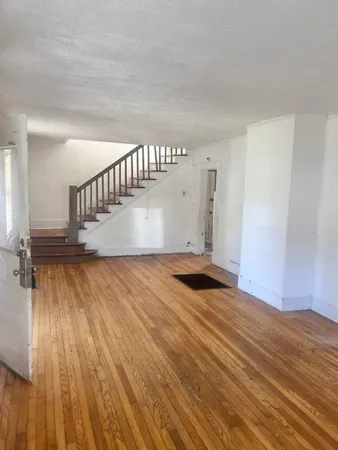 a view of wooden floor and staircase in a room