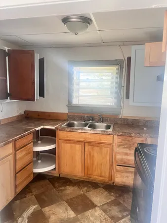 a kitchen with stainless steel appliances granite countertop a sink and a stove