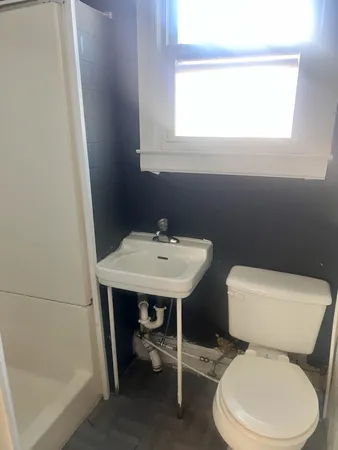 a white toilet sitting next to a bathroom sink