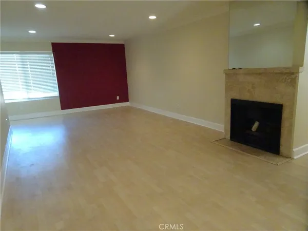 a view of an empty room with a fireplace